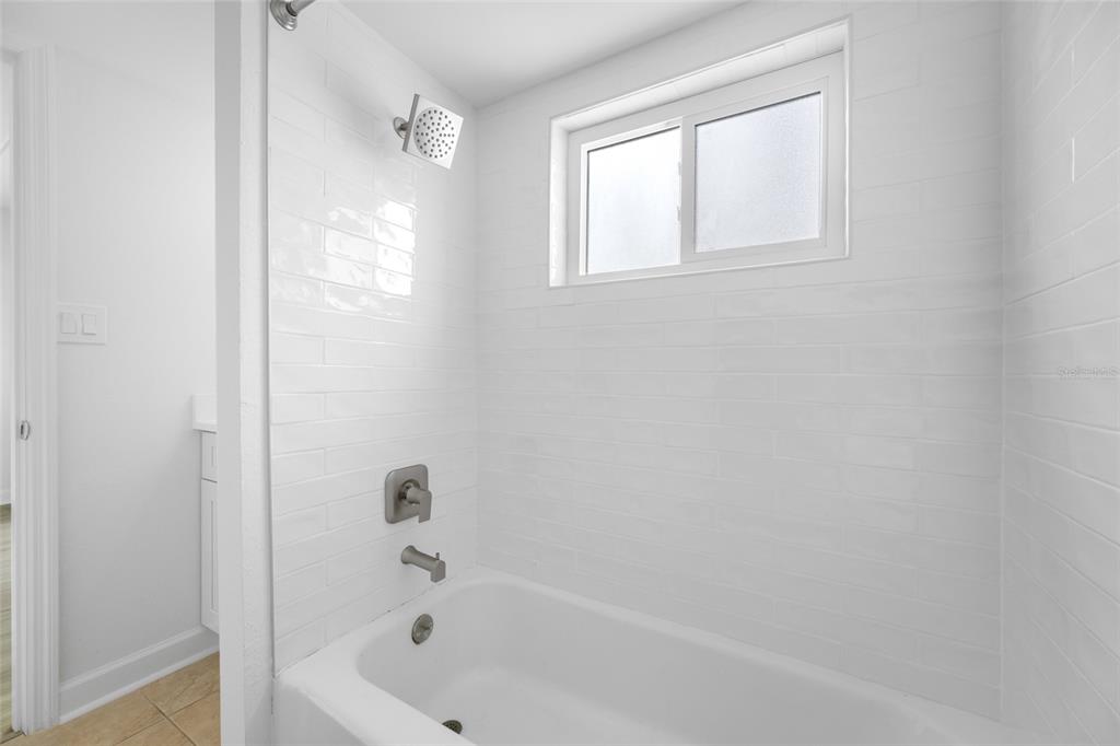 8911 Blind Pass Road, Unit 114 St. Pete Beach, FL 33706 - Photo 30 of 43 a bathroom with a bathtub