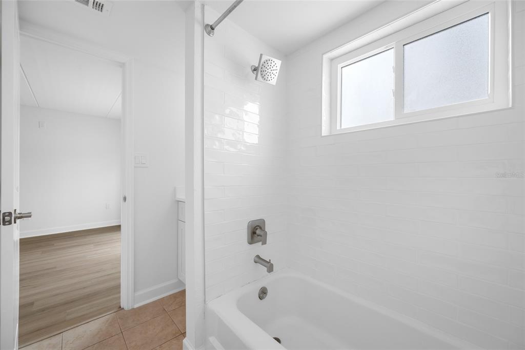 8911 Blind Pass Road, Unit 114 St. Pete Beach, FL 33706 - Photo 31 of 43 a bathroom with a bathtub