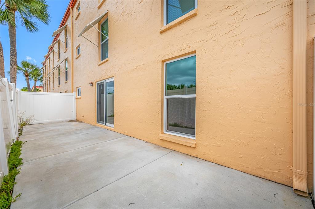 8911 Blind Pass Road, Unit 114 St. Pete Beach, FL 33706 - Photo 34 of 43 a view of a house with a yard