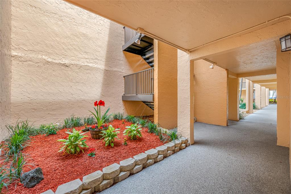 8911 Blind Pass Road, Unit 114 St. Pete Beach, FL 33706 - Photo 9 of 43 a front view of a house with a yard