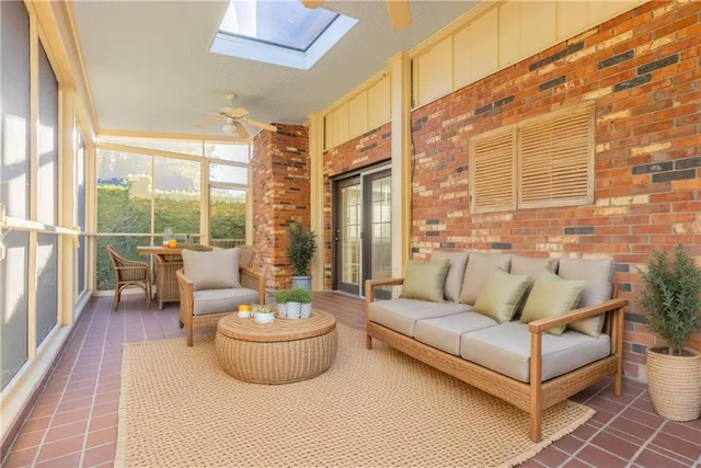 a living room with furniture and a floor to ceiling window