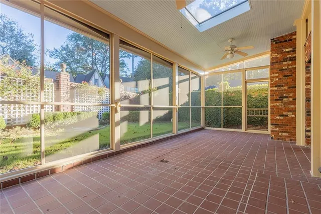 a view of a room with wooden floor and windows