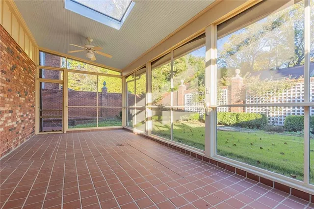 a view of a room with wooden floor and windows