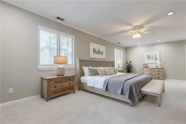 a spacious bedroom with a bed and window