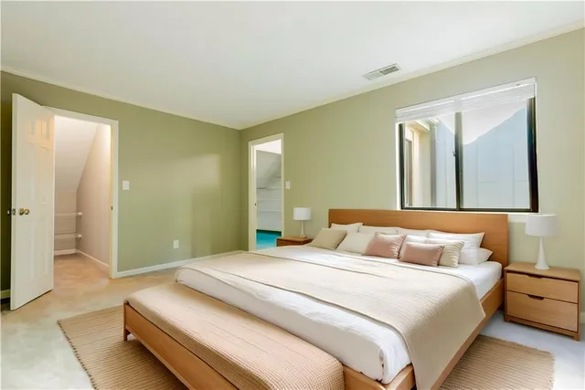 a bedroom with a bed and a painting