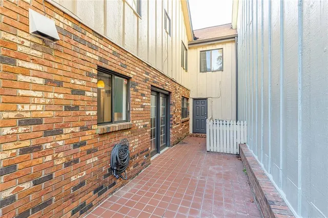 a view of a house with a wooden fence