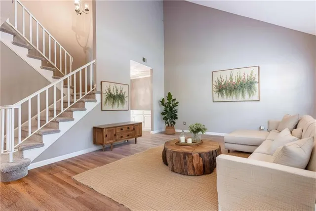 a living room with furniture and a chandelier