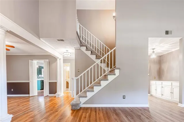 a view of entryway and hall with wooden floor