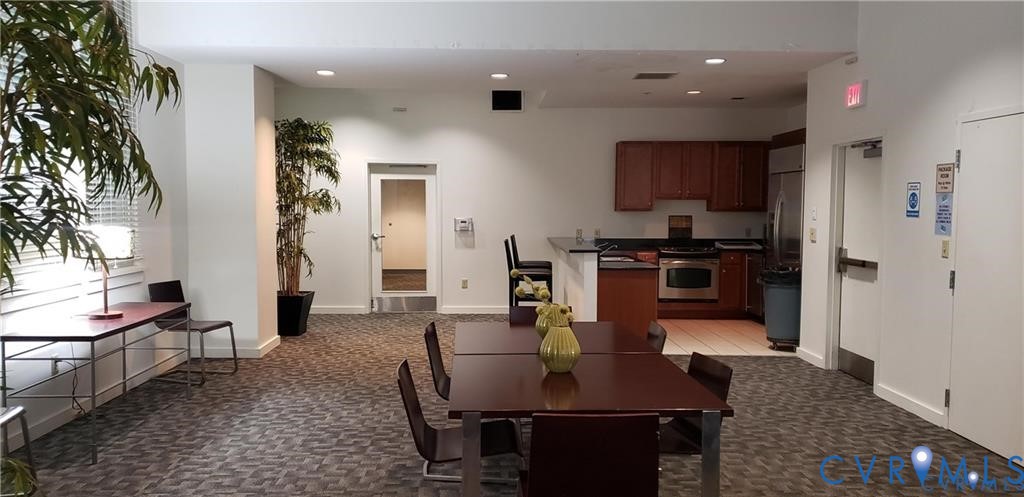 230 North 6th Street, Unit U512 Richmond, VA 23219 - Photo 14 of 15 a kitchen with stainless steel appliances granite countertop a stove a sink a refrigerator and a dining table