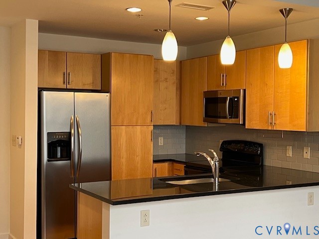 230 North 6th Street, Unit U512 Richmond, VA 23219 - Photo 3 of 15 a kitchen with stainless steel appliances granite countertop a refrigerator a microwave a sink and a stove