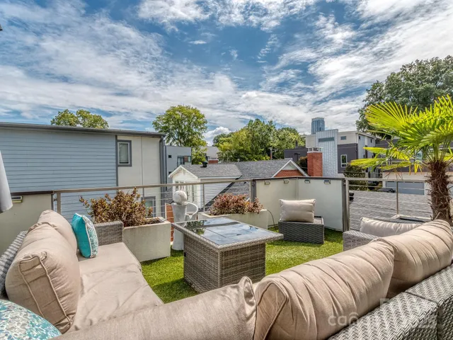a view of a patio with couches and potted plants