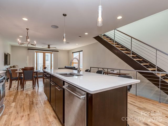 a large kitchen with a table and chairs