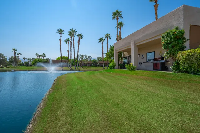 a view of a house with a yard and a patio