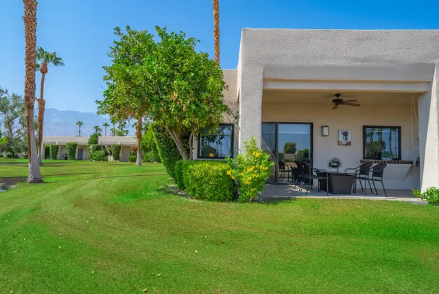 a front view of house with yard and outdoor seating