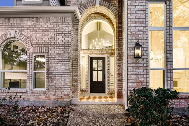 a view of a brick house with large windows