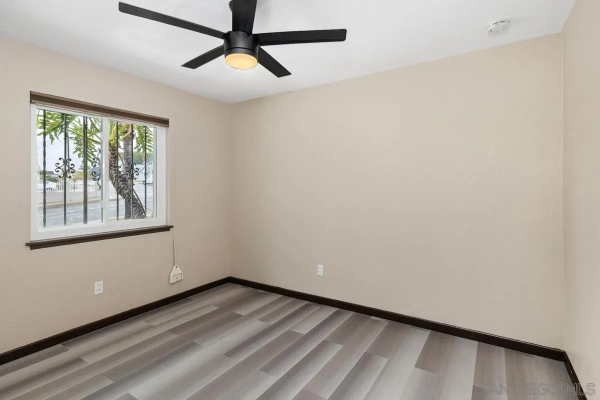 348 Sychar Road San Diego, CA 92114 - Photo 15 of 30 a view of empty room with wooden floor and fan