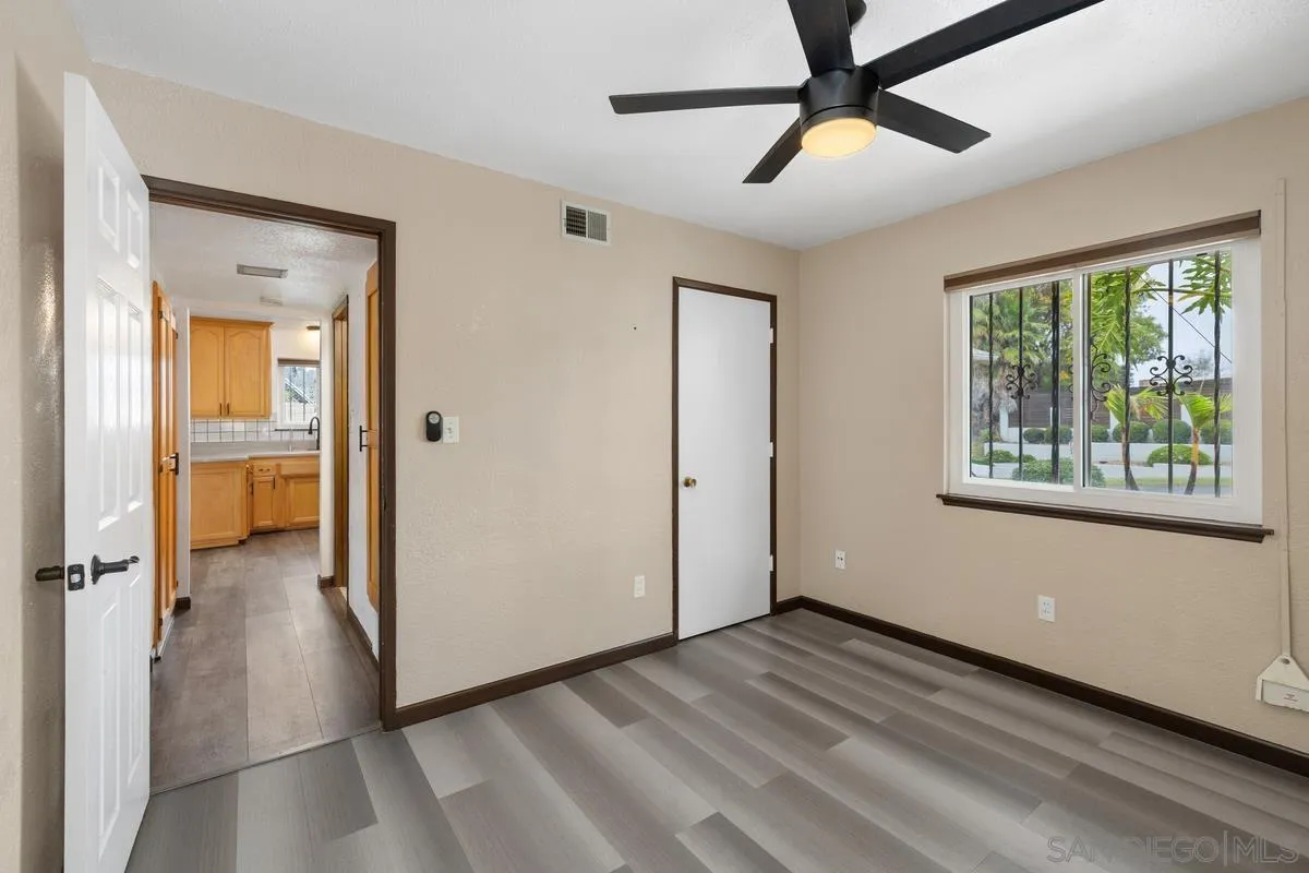348 Sychar Road San Diego, CA 92114 - Photo 16 of 30 a view of empty room with wooden floor and fan