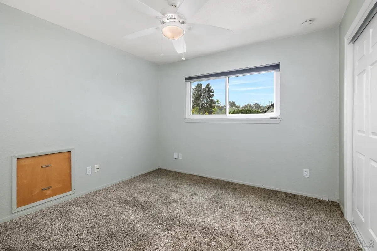 348 Sychar Road San Diego, CA 92114 - Photo 25 of 30 an empty room with a window and a ceiling fan