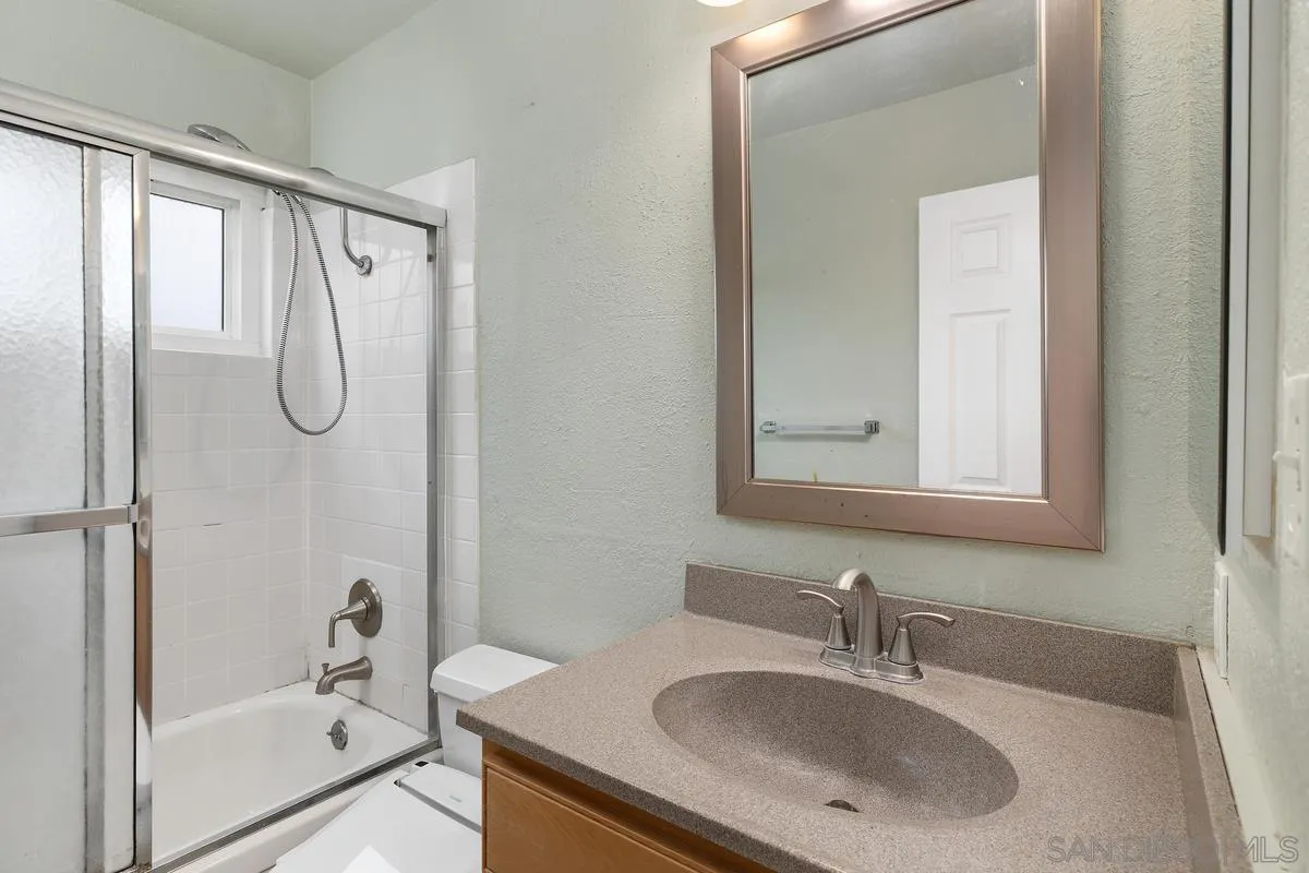 348 Sychar Road San Diego, CA 92114 - Photo 27 of 30 a bathroom with a granite countertop sink a shower and a mirror