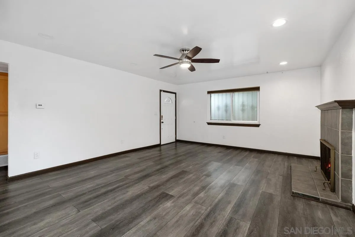 348 Sychar Road San Diego, CA 92114 - Photo 5 of 30 a view of an empty room with a window and wooden floor