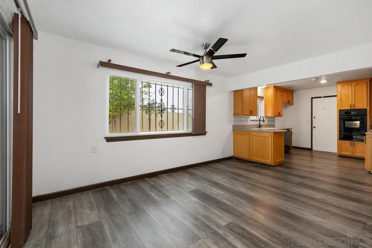 348 Sychar Road San Diego, CA 92114 - Photo 7 of 30 a view of an empty room with a window and wooden floor