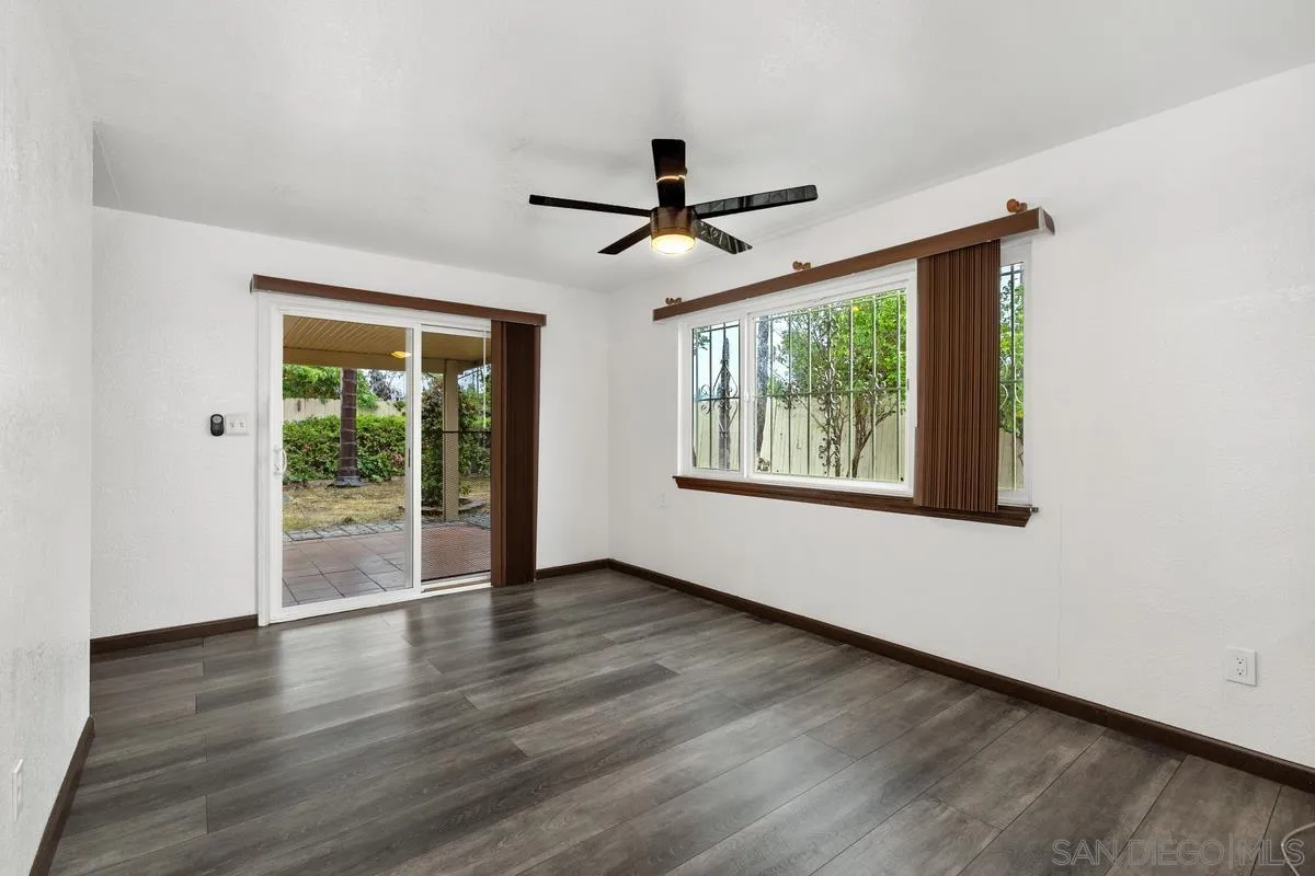 348 Sychar Road San Diego, CA 92114 - Photo 8 of 30 a view of an empty room with wooden floor and a window