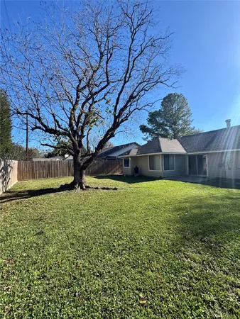 a view of yard with swimming pool and green space