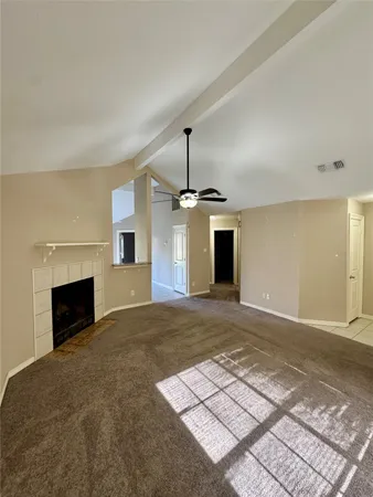 a view of empty room with a fireplace