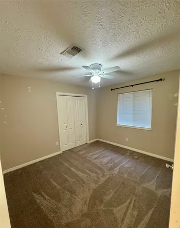 a kitchen with stainless steel appliances granite countertop a sink window and cabinets