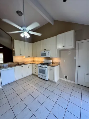 a kitchen with stainless steel appliances a stove sink and cabinets