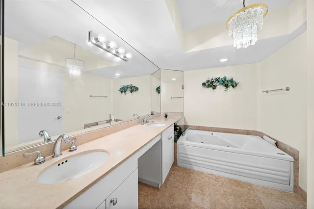 a spacious bathroom with a sink a large mirror and a bathtub