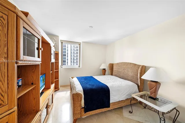 a bedroom with a bed and two windows