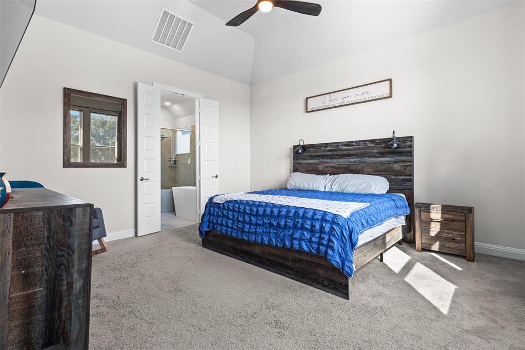 305 Monument Place Azle, TX 76020 - Photo 14 of 29 a bedroom with a bed and a chandelier