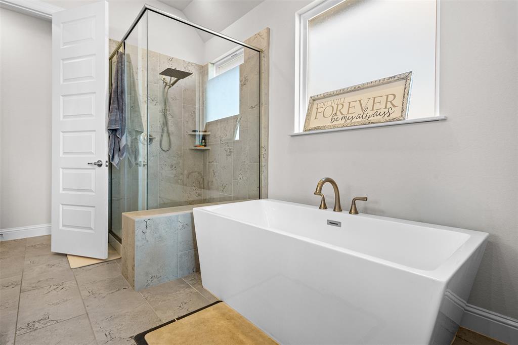 305 Monument Place Azle, TX 76020 - Photo 15 of 29 a white bath tub sitting next to a bathroom
