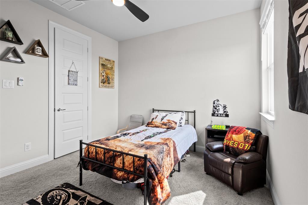 305 Monument Place Azle, TX 76020 - Photo 16 of 29 a bedroom with a bed and a couch