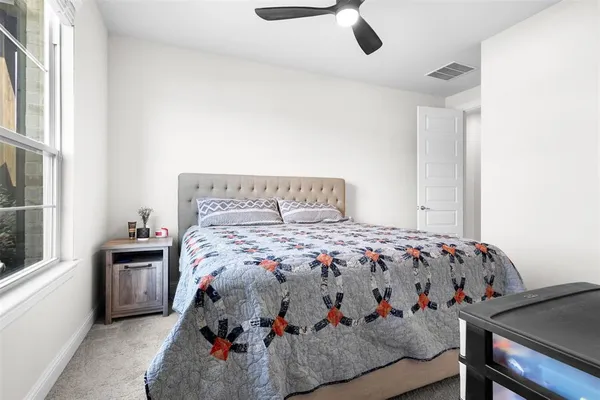 a bedroom with a bed and window