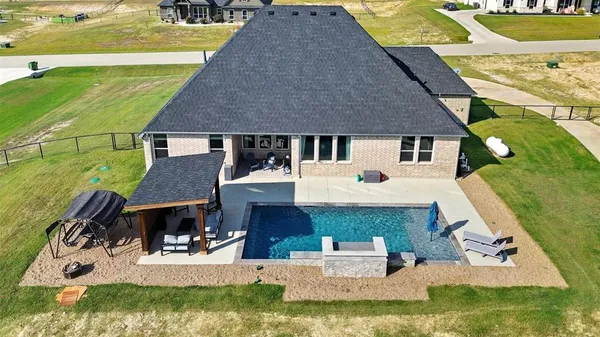 an aerial view of a house with swimming pool