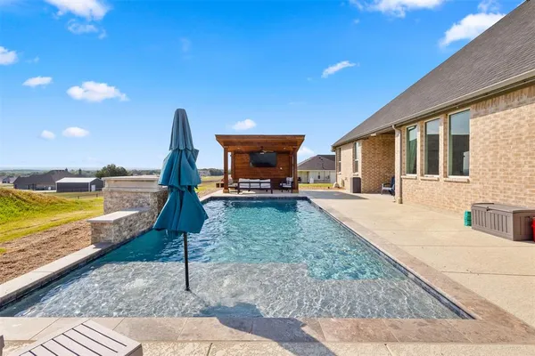 a swimming pool with outdoor seating