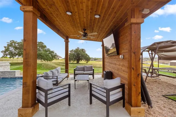 a outdoor living space with patio furniture and a fireplace