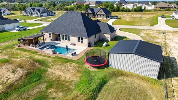 swimming pool view with a seating space and a garden