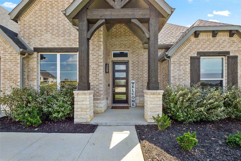 305 Monument Place Azle, TX 76020 - Photo 4 of 29 a front view of a house with garden