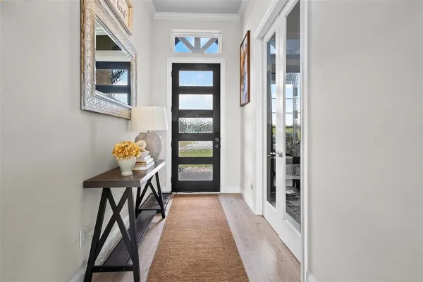 a view of a hallway to a livingroom with furniture