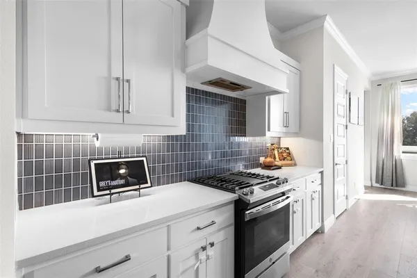 a kitchen with cabinets appliances and a wooden floor