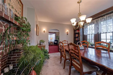 a view of a dining room with furniture and chandelier