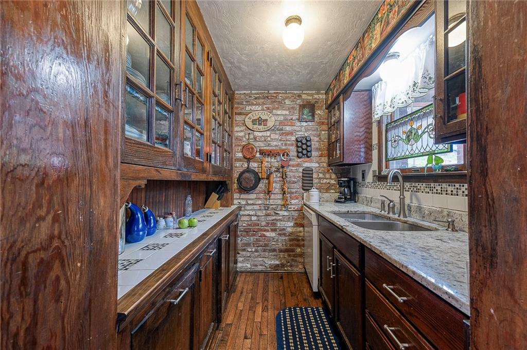 451 Walnut Street Pittsburgh, PA 15238 - Photo 12 of 40 a kitchen with stainless steel appliances granite countertop lots of counter top space and wooden floor