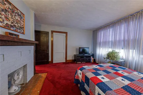 a bedroom with a bed and flat screen tv