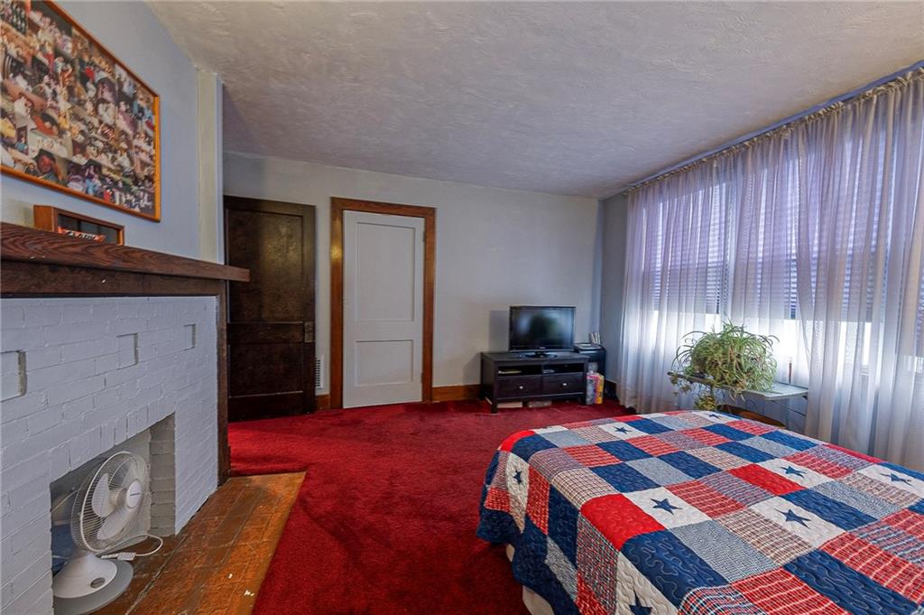 451 Walnut Street Pittsburgh, PA 15238 - Photo 19 of 40 a bedroom with a bed and flat screen tv