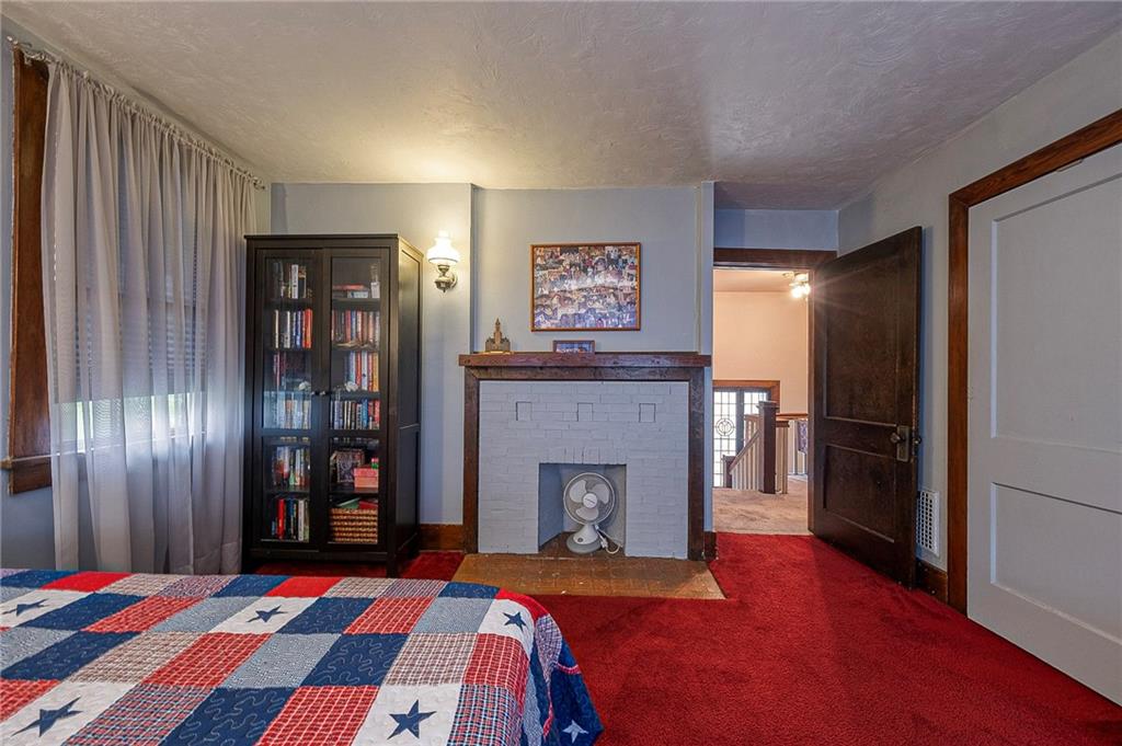 451 Walnut Street Pittsburgh, PA 15238 - Photo 20 of 40 a bedroom with a bed and a fireplace
