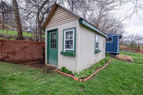 a aerial view of a house with a yard and plants