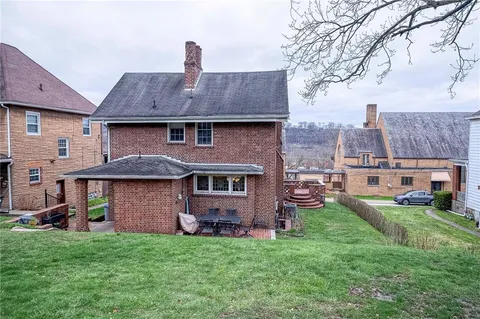 a front view of a house with a garden and yard